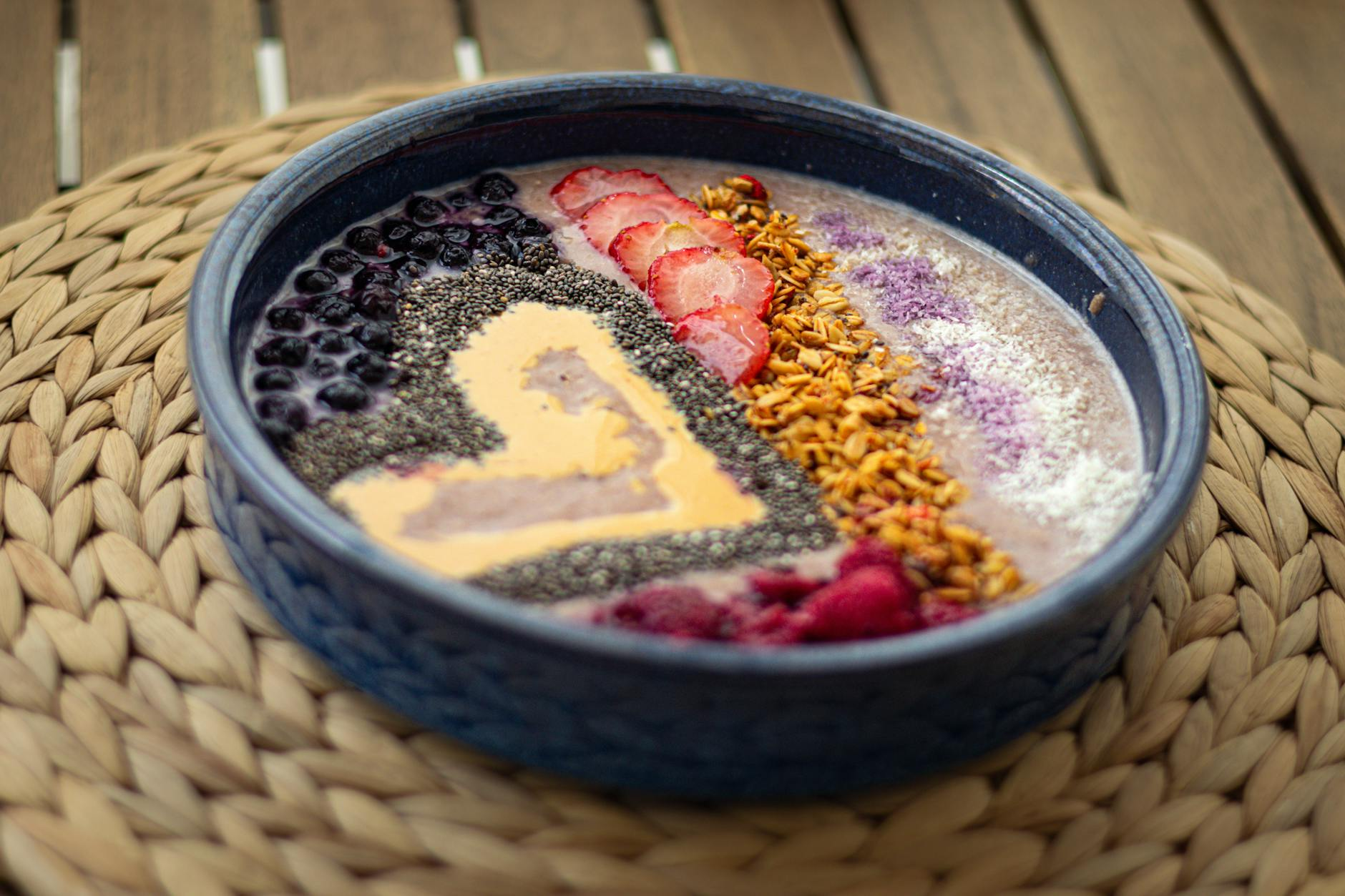 Colorful spread of high-fiber foods including lentils, chia seeds, berries, whole grains, and fresh vegetables on a wooden table