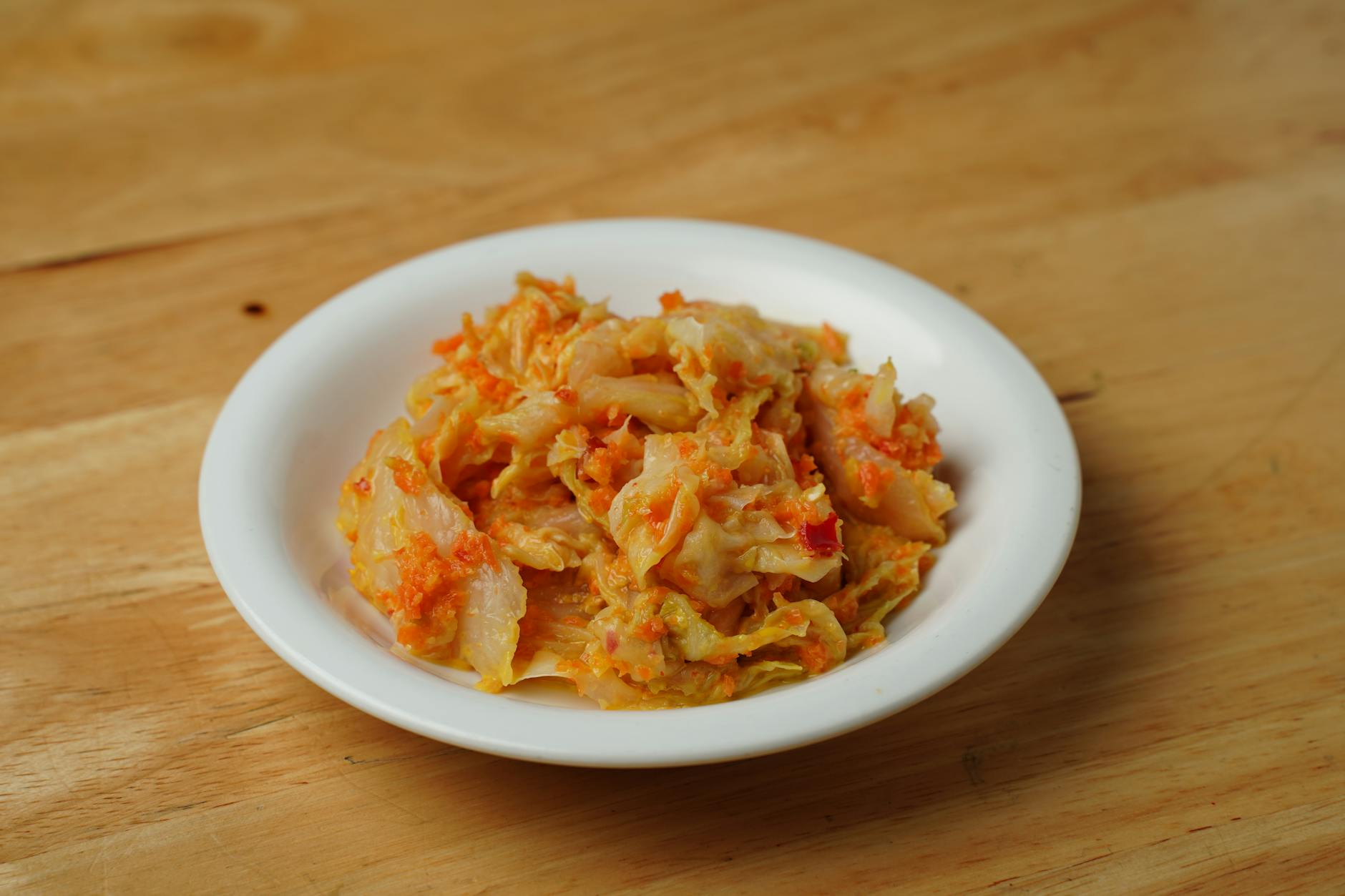 Fermented foods including yogurt, kimchi, sauerkraut, and kombucha alongside fresh vegetables and whole grains on a table