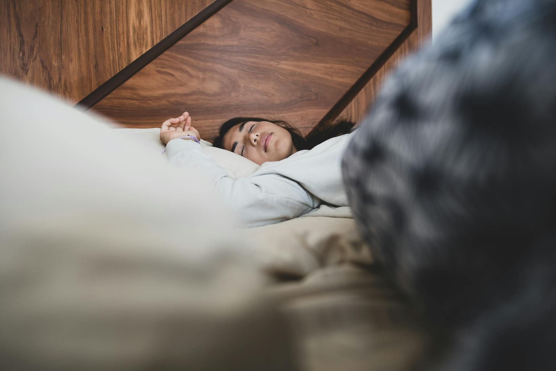 Person sleeping peacefully in a calm bedroom illustrating restorative sleep that supports balanced hunger hormones