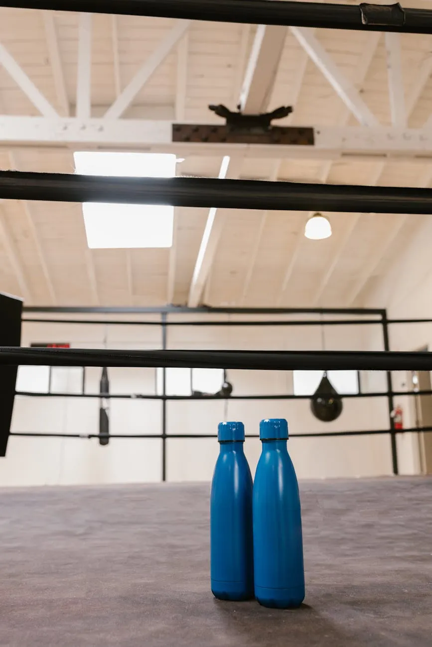 Reusable water bottle and a fitness towel on a gym mat to illustrate hydration during exercise and workouts