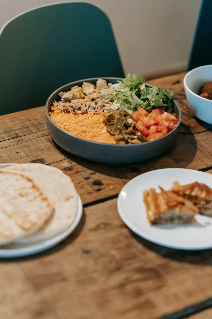 Smartphone displaying a daily calorie target alongside a balanced meal with grilled chicken, vegetables, and grains on a kitchen table