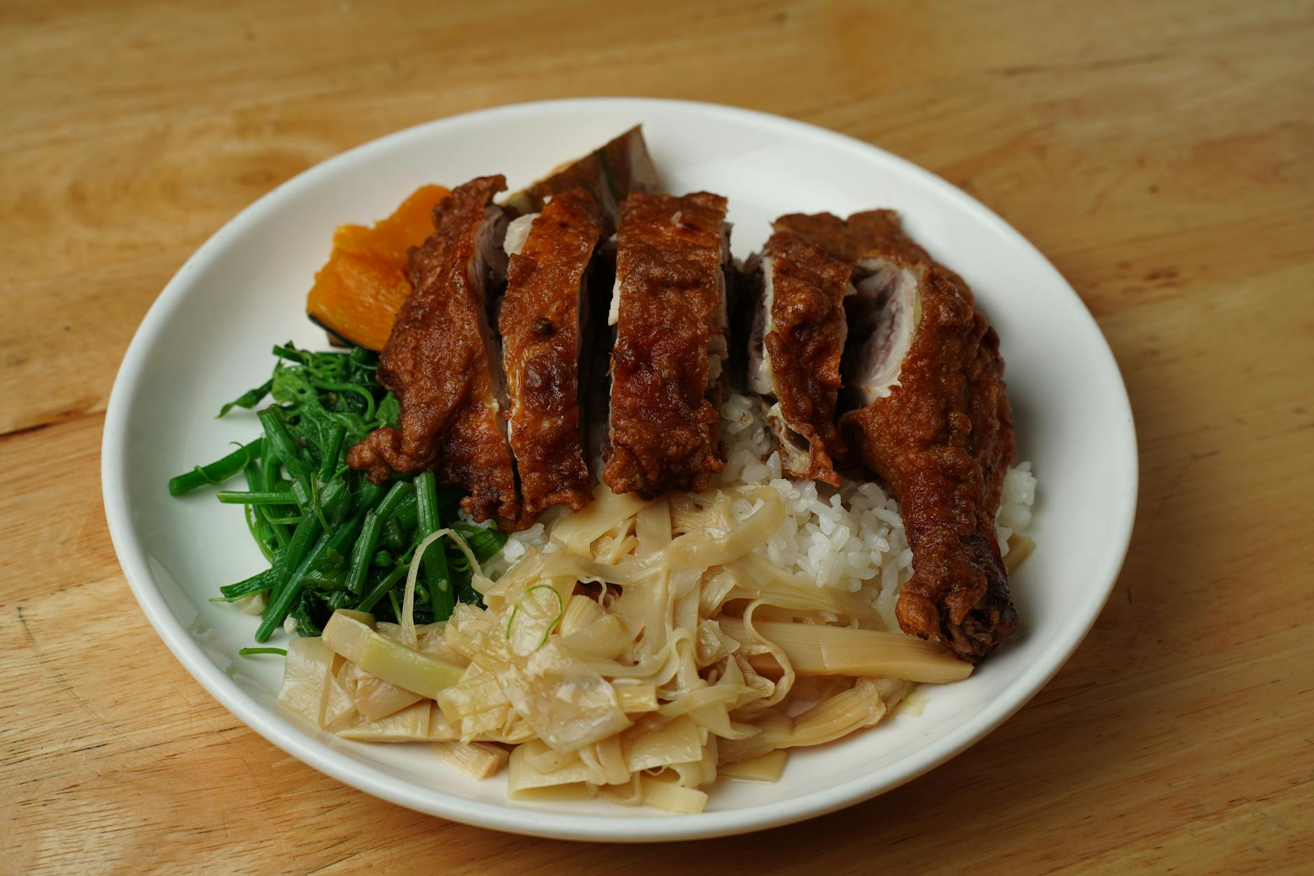Athletic person preparing a high-protein meal with grilled chicken, rice, and vegetables after a workout
