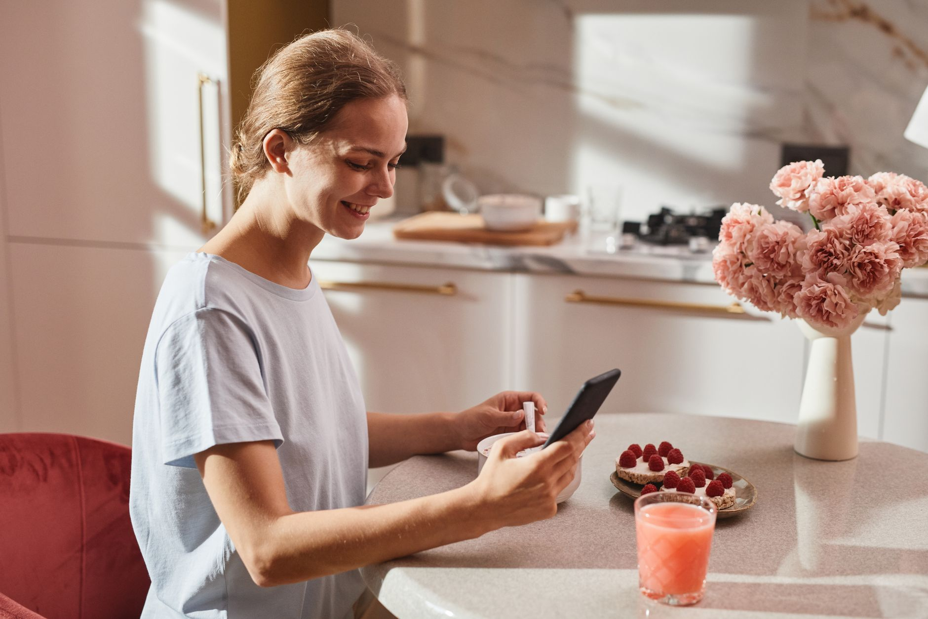A zero-sugar protein bar with its nutrition label beside sugar-free sweetener sachets, a digital kitchen scale, and a smartphone showing a calorie tracking app on a sunlit kitchen counter, illustrating the calories sugar alcohols still add to a food log