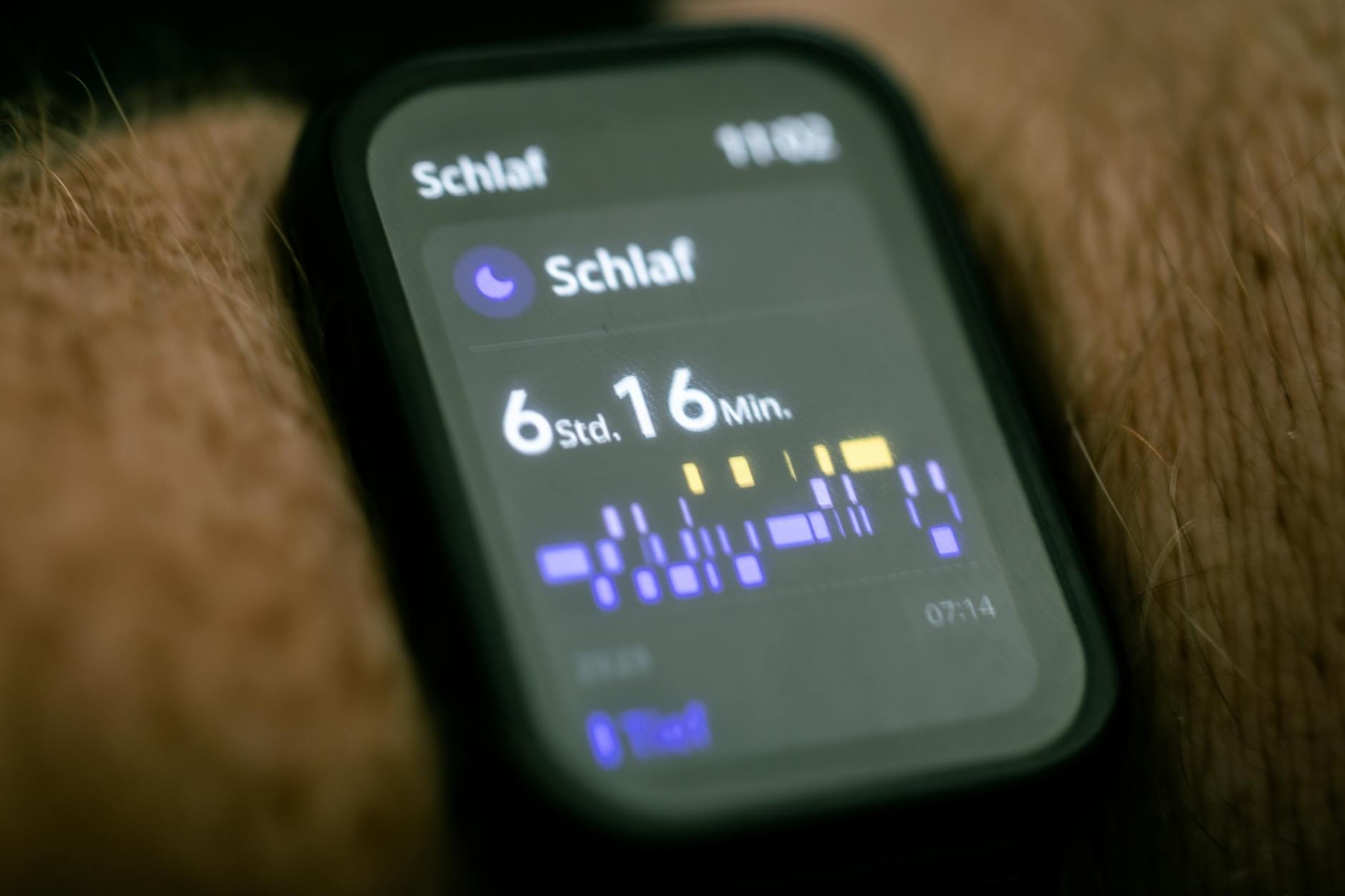Person checking sleep data on a smartwatch in the morning next to a nutritious breakfast with oatmeal fruit and coffee